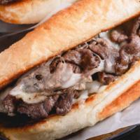 Philly Steak Sandwich · Tender seasoned steak, cheese, crisp lettuce, chopped onions, fresh tomatoes and topped with...