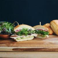 The California Turkey Sandwich · Turkey, avocado, mixed greens, tomato, red onion, basil aioli, lemon vinaigrette, served on ...