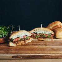 The RSTLNE Sandwich · Housemade vegan coconut bacon jam, vegan bacon, mixed greens, tomato, q-cucumber, vegan basi...