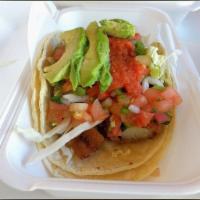 Fish Taco · Breaded and fried fish on a corn tortilla topped with cabbage, avocado, pico de Gallo, and a...