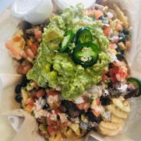 Fry- Nacho · Nachos served on crispy waffle fries. Topped with cheese, pico, poblano corn and bean and Da...