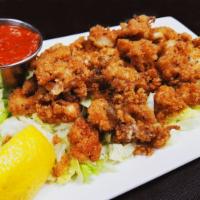 Crispy Calamari · Hand breaded, lightly fried, and sprinkled with aged parmesan. Served with marinara.