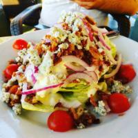 Wedge Salad · A cool & crispy wedge of Iceberg topped with crumbled blue cheese, bacon, cherry tomatoes, r...