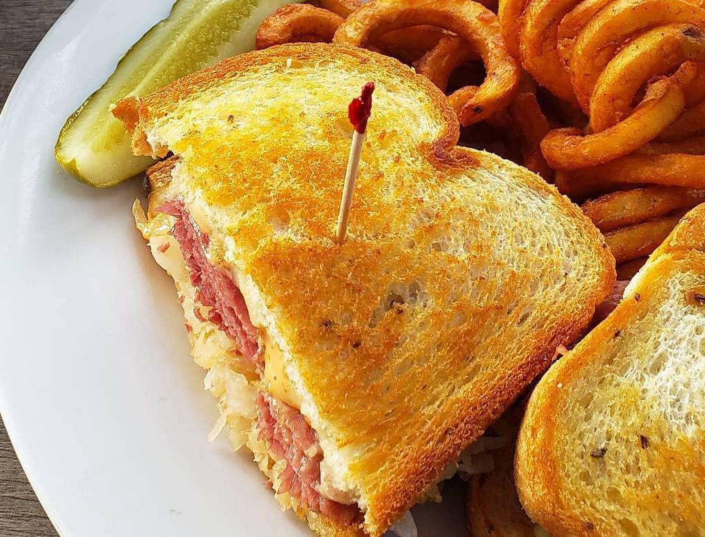 Reuben Sandwich · Flavorful corned beef, Swiss cheese, sauerkraut, & 1000 Island dressing stacked on toasty rye bread.Served with your choice of French fries or housemade coleslaw. Upgrade to any House Side for an additional $4. Gluten Free Bun $1.50