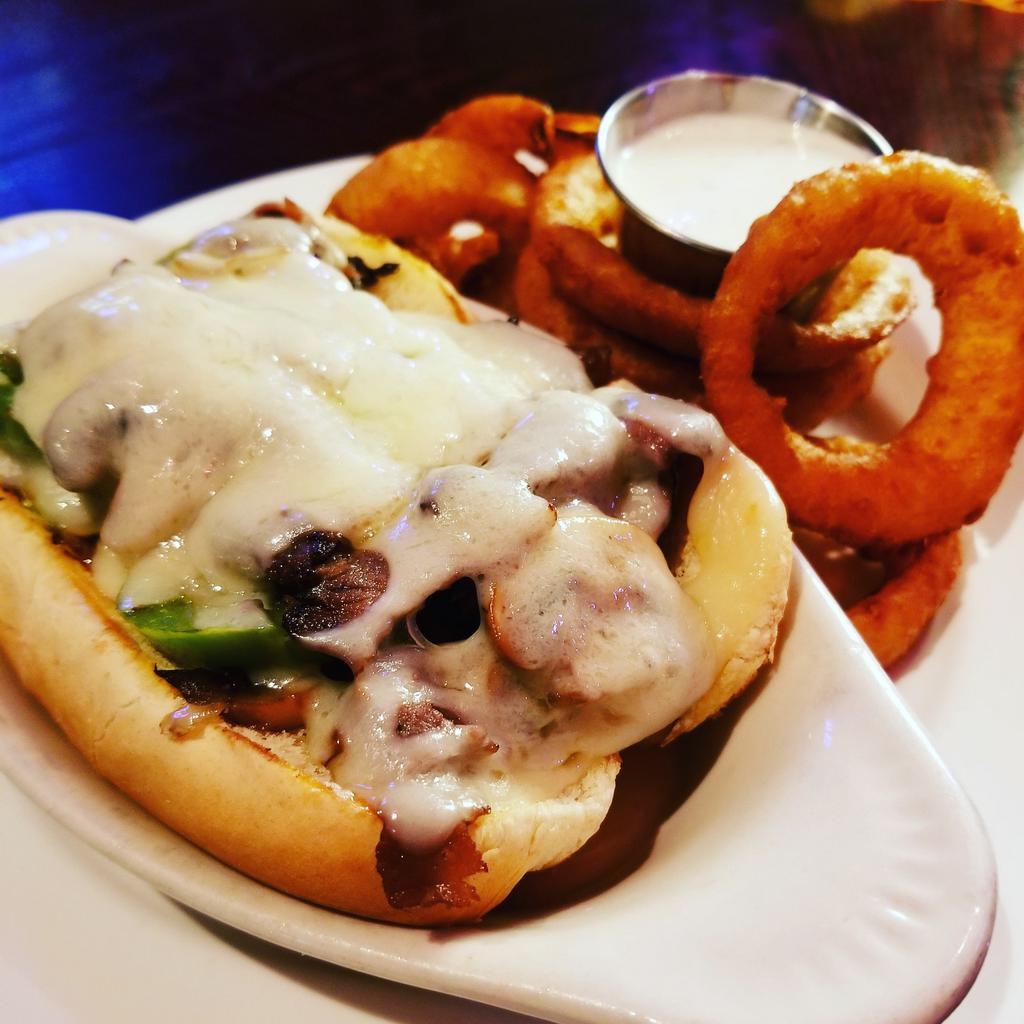 Philly Cheesesteak Sandwich · Thinly sliced beef with sautéed onions, mushrooms & peppers topped with melted Swiss cheese. Served with your choice of French fries or housemade coleslaw. Upgrade to any House Side for an additional $4. Gluten Free Bun $1.50