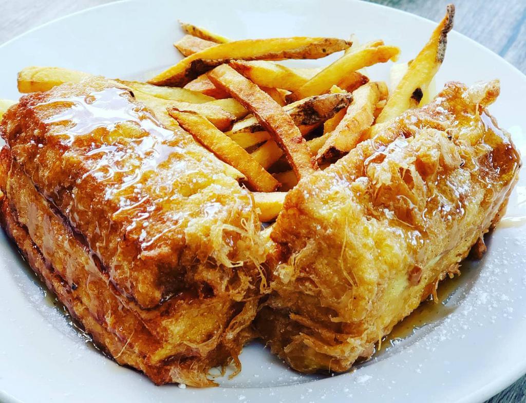 The Full Monte Cristo · Turkey, ham & swiss cheese dipped in egg batter & lightly fried. Topped with powdered sugar & served with strawberry jam & maple syrup. Served with your choice of French fries or housemade coleslaw. Upgrade to any House Side for an additional $4. 