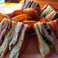 Triple Decker Club Sandwich · Toasted sourdough bread bursting with turkey, bacon, tomato and lettuce. Served with your ch...