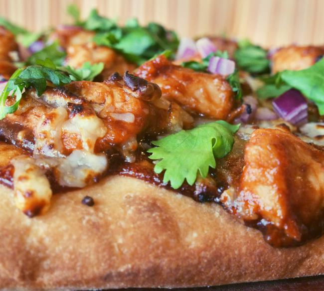 Tuscan Style BBQ Chicken · A base of our tangy sauce topped with shredded mozzarella, bbq chicken, red onion and cilanro.