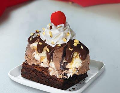 Brownie Sundae · Top off a brownie with two of your favorite ice cream flavors, your choice of wet topping, chopped almonds, and a cherry.
