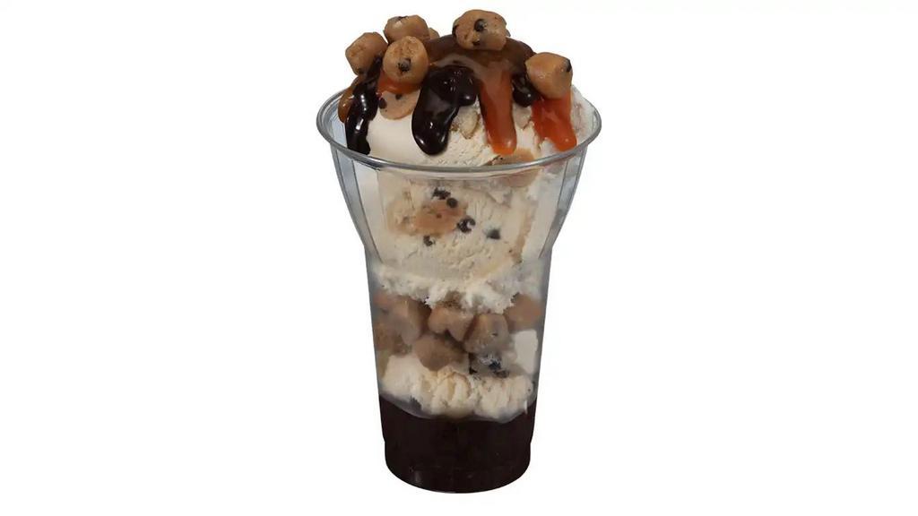 Chocolate Chip Cookie Dough Sundae · 3 scoops of chocolate chip cookie dough ice cream with layers of hot fudge and cookie dough pieces, topped with caramel.
