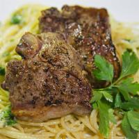 Lamb Chops · Grilled lamb chops served on spaghetti. Served with house salad and garlic bread. Garnished ...