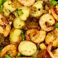 SeaQue Delight · Peel and Eat Shrimp in Spicy Garlic Butter, Cajun Corn and Potatoes, Sausage, Boiled Egg, Br...