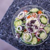 Traditional Village Salad · Tomatoes, cucumbers, bell peppers, red onion, Kalamata olives, feta cheese and tossed with e...