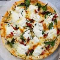 Italiano Pizza · No red sauce. Olive oil, garlic, ricotta, spinach, sundried tomatoes and our mozzarella  ble...