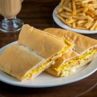 Pan con Tortilla  · Scramble eggs with ham, cheese and onion on a XL Cuban bread toast.