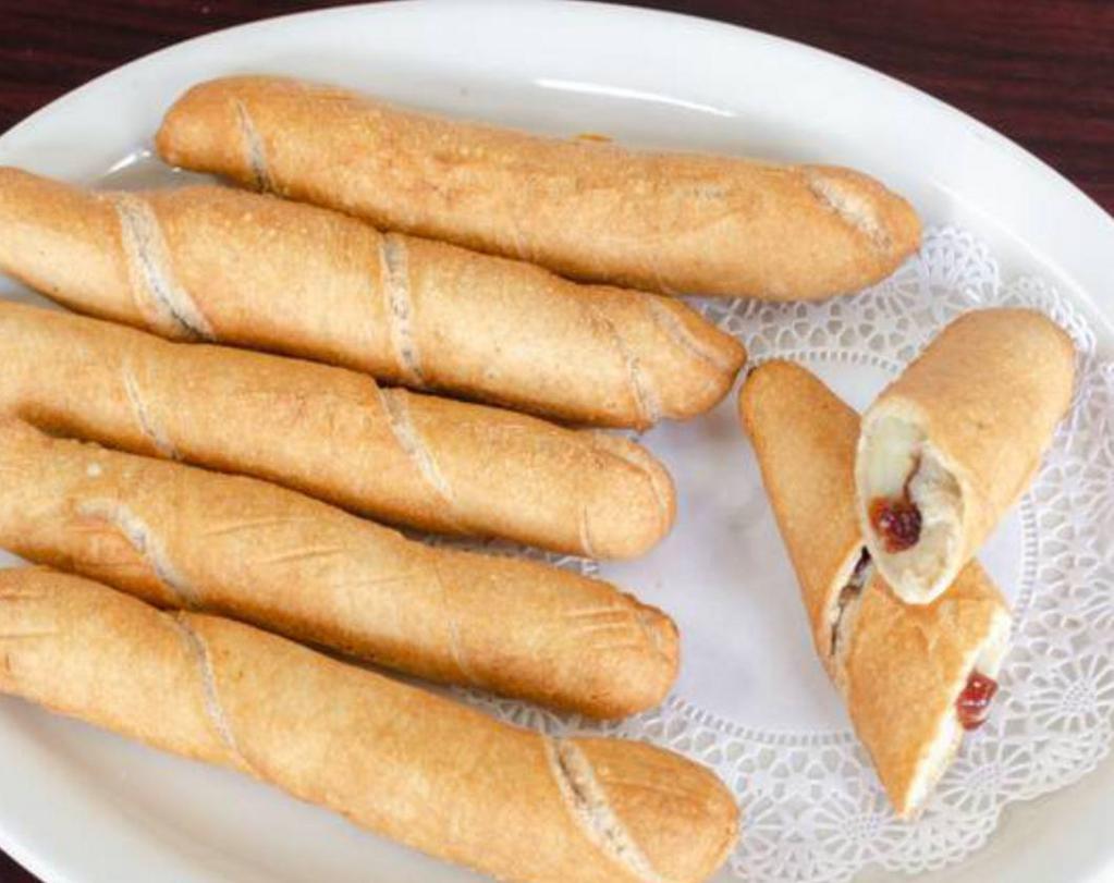 Tequeños · Venezuelan fried cheese or guava stick wrapped in thin dough.