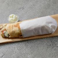 Mix Shawarma Sandwich · Beef and chicken shawarma rolled with pickles, onions, tomatoes and garlic sauce.