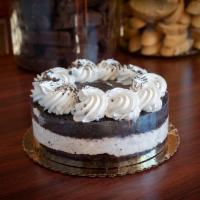 Oreo Mousse Cake · Two layers of dark chocolate cake filled with a creamy house made oreo mousse, topped with c...