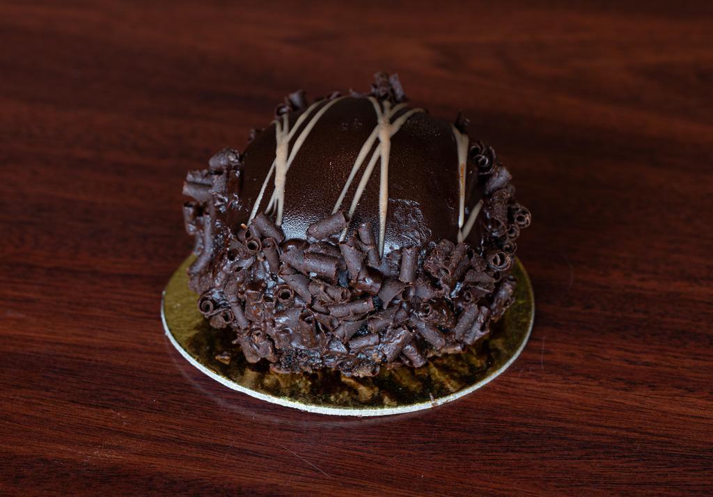 Chocolate Truffle Bomb · Chocolate Cake Filled with a rich chocolate Mousse and draped in Chocolate Ganache