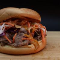Original Butt Sandwich · Shredded smoked pork topped with house made coleslaw and pickles and drizzled with our speci...