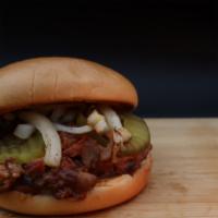BBQ Butt Sandwich · Shredded smoked pork tossed in BBQ sauce with grilled onions and pickles.