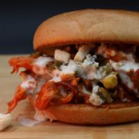 Buffalo Butt Sandwich · Shredded smoked pork tossed in Buffalo sauce topped with jalapenos and blue cheese rumbles d...