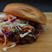 Spicy Jerk Butt Sandwich · Shredded smoked pork marinate in our special jerk sauce and seasoning topped with slaw.
