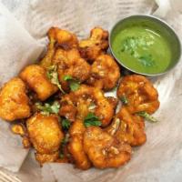 Cauliflower Pakora · Organic cauliflower breaded with chickpea flour and fried to perfection served with mint and...