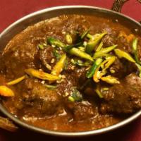 Goat Curry · Bone-in goat cooked with onions, tomatoes and Nepali spices. Served with basmati rice.