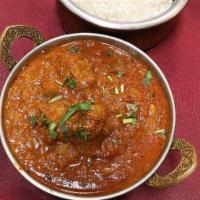 Lamb Curry · Boneless lamb cooked in tomato and onion sauce with spices. Served with basmati rice.