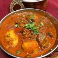 Lamb Vindaloo · Hot and spicy recipe with boneless lamb and potatoes cooked in a tangy sauce. Served with ba...