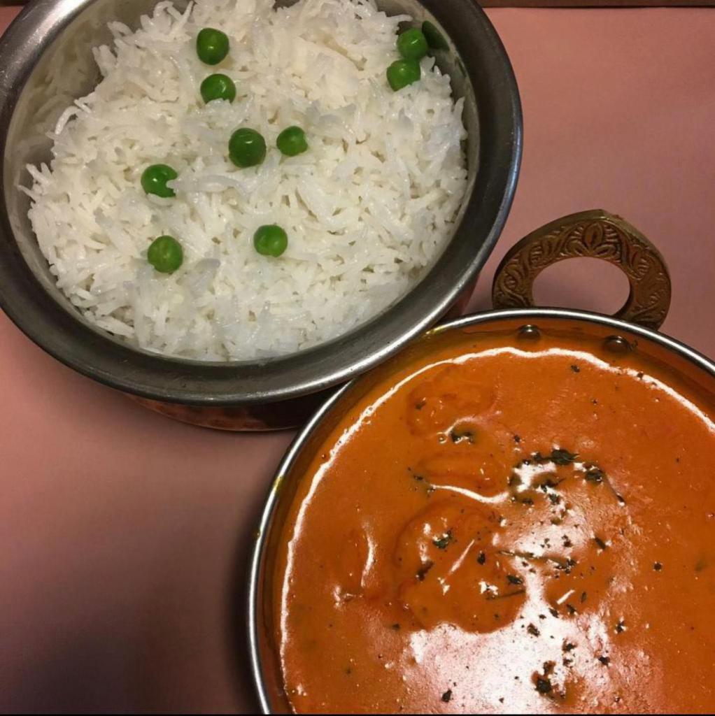 Shrimp Tikka Masala · Marinated shrimp cooked in a wok with tomatoes, onions, bell peppers, garlic and ginger. Served with basmati rice.