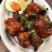 Tandoori Chicken · Bone-in chicken pieces marinated overnight in yogurt, ginger, garlic, and spices and cooked ...