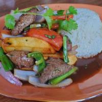 LOMO SALTADO` · Traditional Peruvian style stir fry beef tenderloin mixed in with potato fries, tomatoes, ci...