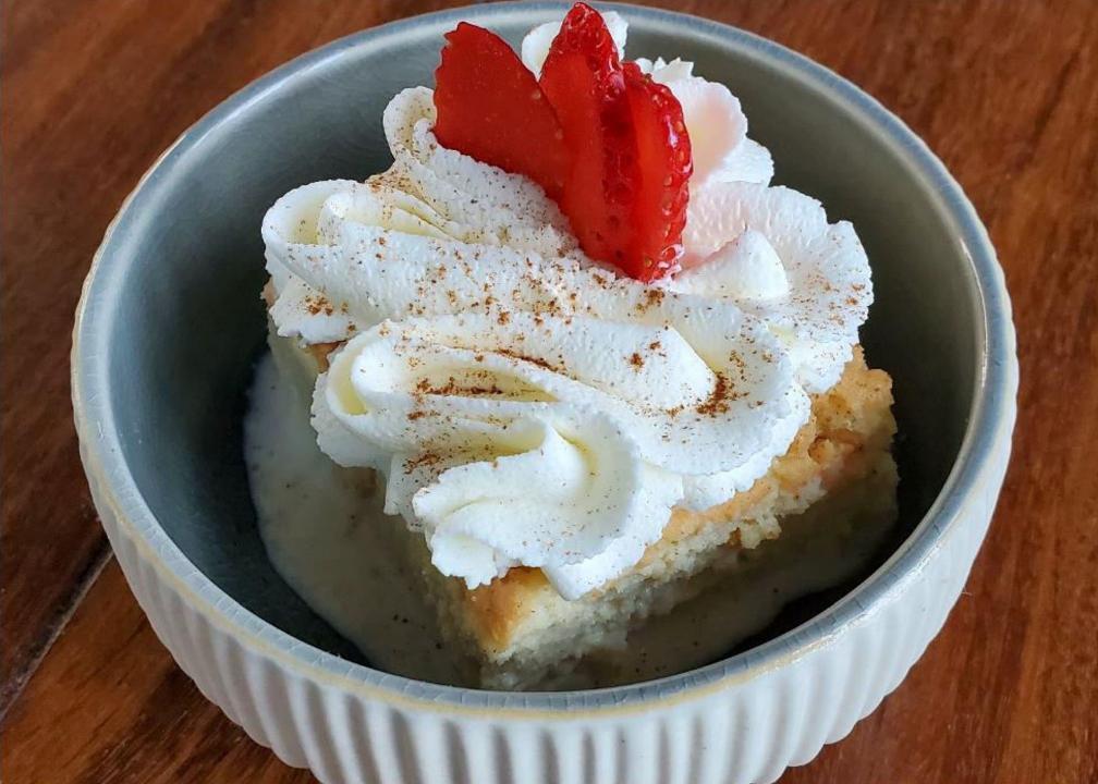 TRES LECHES · Sponge cake soaked in a mix of three different type of milk served with whipped cream strawberries.