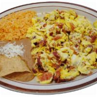 Huevos con Tocino Breakfast · Scrambled eggs with bacon. Served with rice and beans 