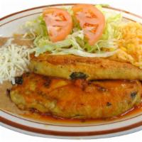 Chiles Rellenos Platillo · Stuffed poblano pepper topped with tomato sauce. Served with rice, beans, salad and tortillas.