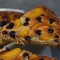 Blueberry Peach Tart · Lucious Peaches and blueberries in a buttery tart mixed with almond crema
