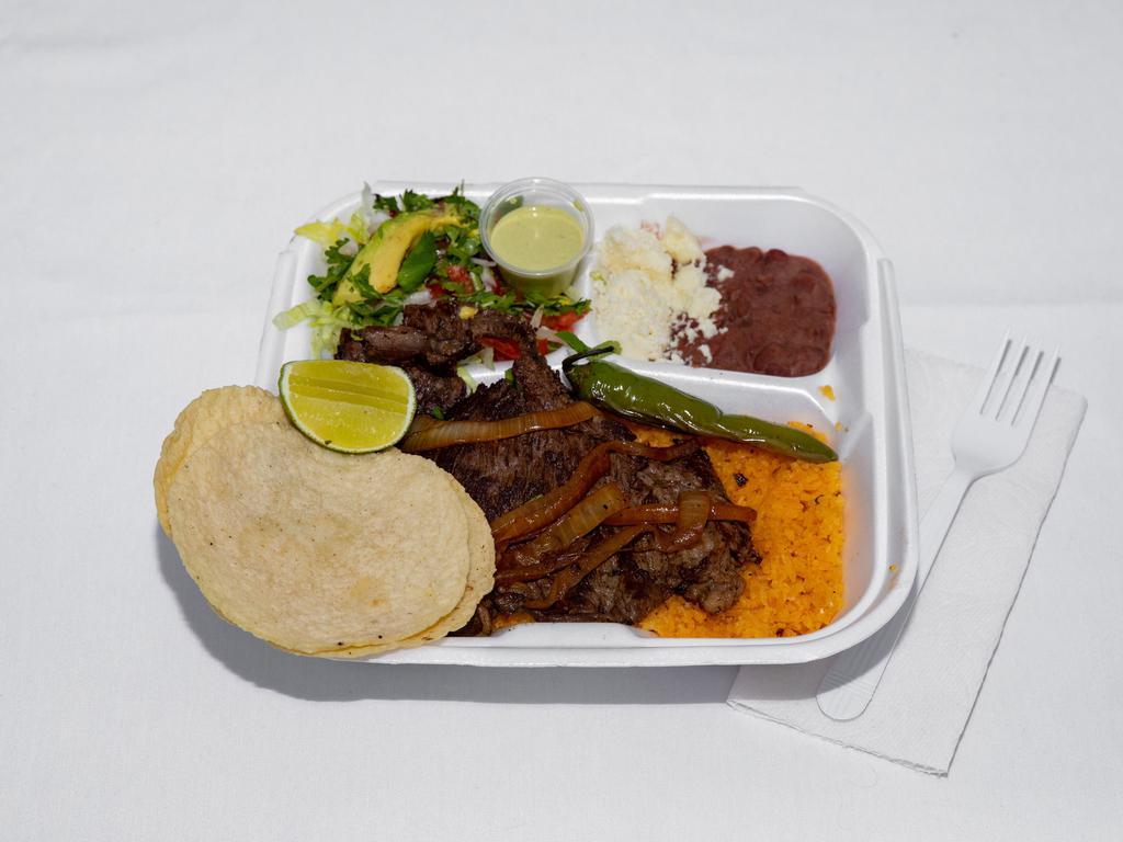 Carne Asada lunch · carne asada with Rice, red beans, salad, cheese, avocado, corn tortillas, meat, chili peppers and roasted onions.