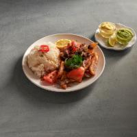 Lomo Saltado · Tender steak sauteed in olive oil with onions and tomatoes served over french fries and rice.