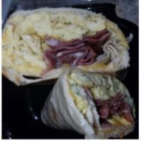 Bacon, Eggs, Cheese, and Sausage Breakfast Wrap · A rolled filled tortilla or flatbread. 