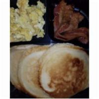 Pancakes , Bacon , and Eggs Breakfast Meal · Flat sweet cake.