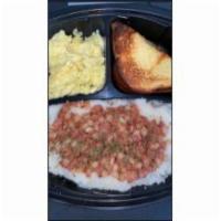 Corn Beef Hash with Grits Eggs and Toast Breakfast Meal · Porridge made from ground corn.