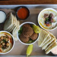 Mezze Platter · Tasting platter of hummus, baba ghanoush and falafel with loads of pita, labneh harissa, tah...