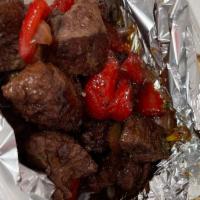 Steak Bites · Tender steak bites with grilled onions and peppers. Served over a small bed of rice. Comes w...