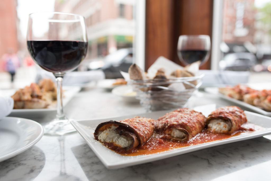 Eggplant Rollatini · Eggplant pan-fried, stuffed with ricotta, plum tomatoes and oven-baked.