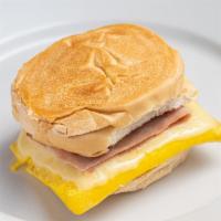 Breakfast Sandwich · Scrambled eggs with white American cheese and Bacon OR Ham on a toasted Cuban Roll