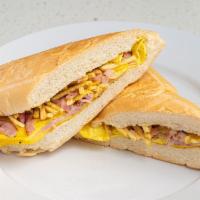 Pan con Tortilla · Egg Omelet with ham ＆ cheese, marinated onions and potato sticks on toasted Cuban bread