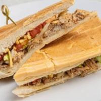 Pan con Lechon · Roasted pork topped with grilled onions, lettuce, tomatoes ＆ potato sticks on toasted Cuban ...