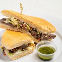 Churrasco Sandwich · Grilled skirt steak topped with grilled onions, lettuce, black bean pico de gallo ＆ potato s...